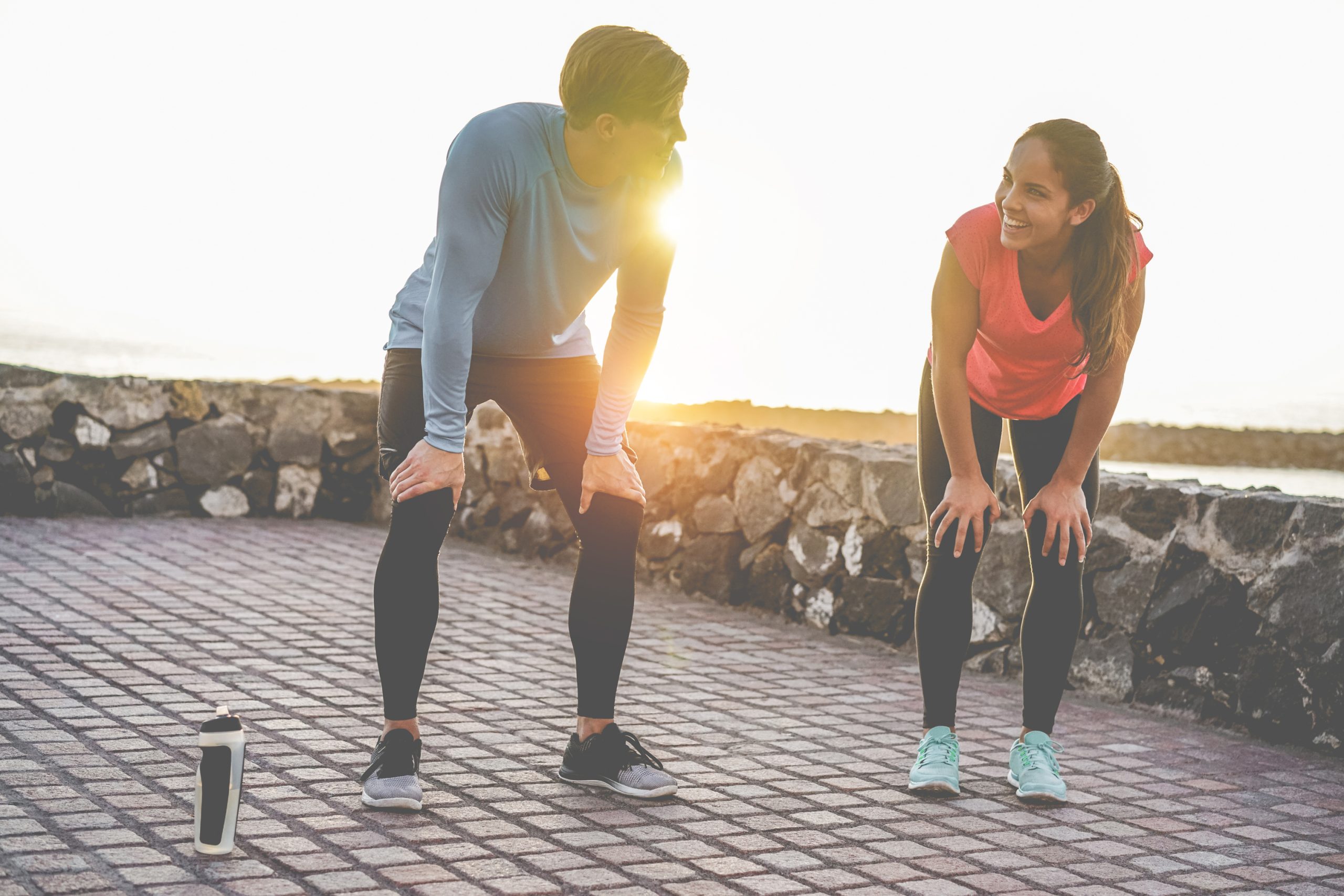 Fit couple taking a rest after fast running workout